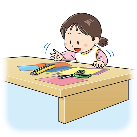 図:机の上に置きっぱなしになっている、はさみやカッターに手を伸ばしている子どものイラスト